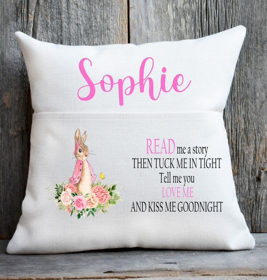 Decorative pillow with a bunny illustration and text on a wooden background