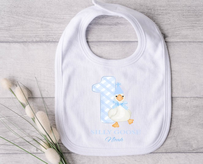 White baby bib with a blue goose design