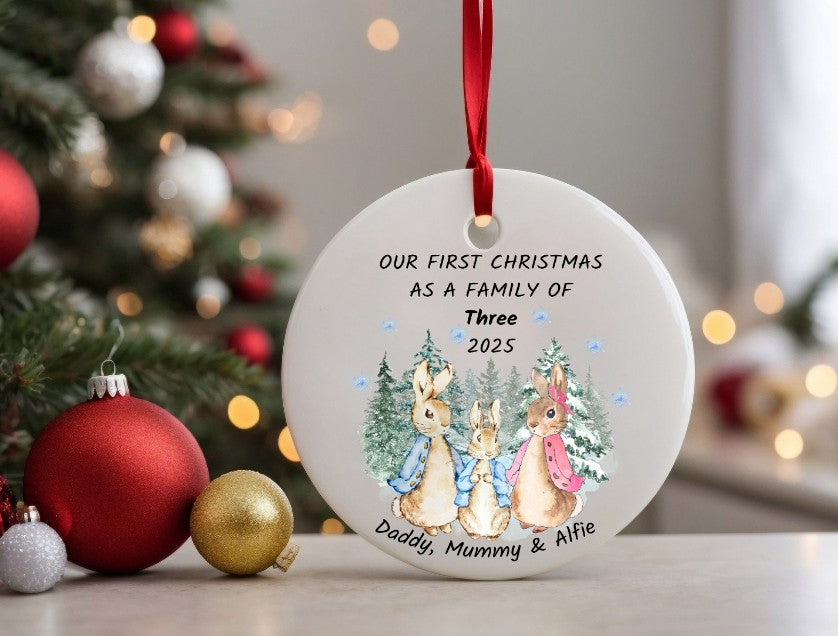 Personalised Christmas ornament with family of three rabbits and festive background