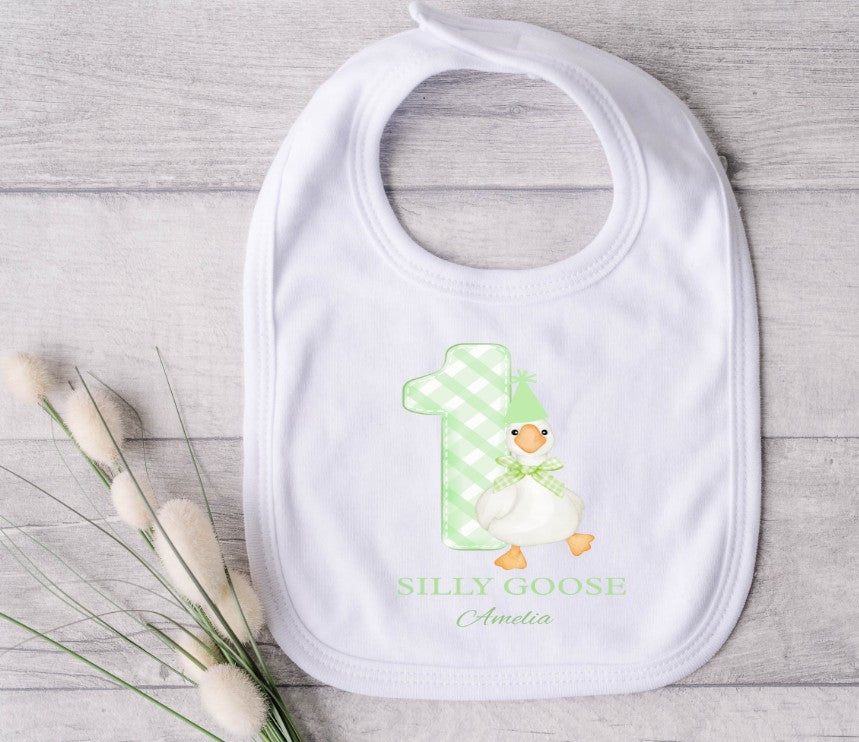 White bib with a green chequered number one and goose design.