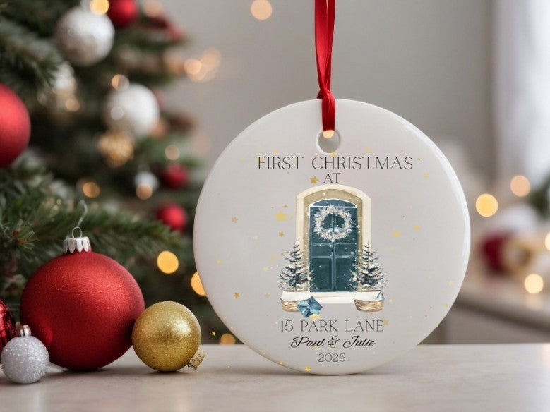 Personalised Christmas ornament with a festive design in front of a decorated Christmas tree.