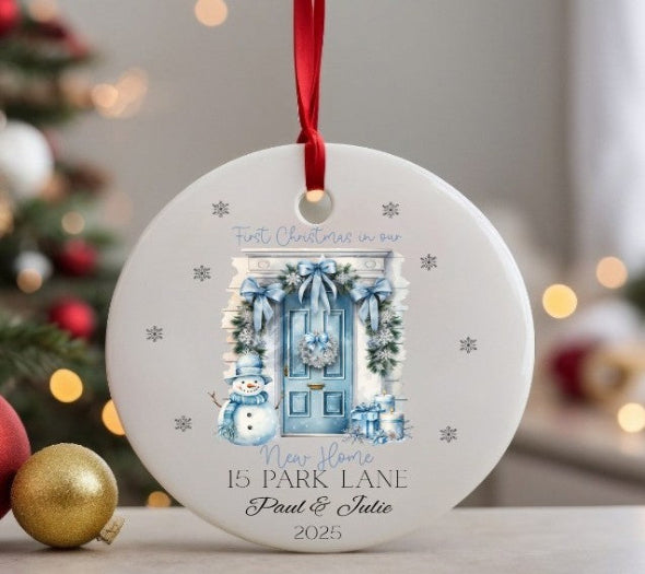 Personalised Christmas ornament with festive design and text, hanging against a blurred Christmas tree background.