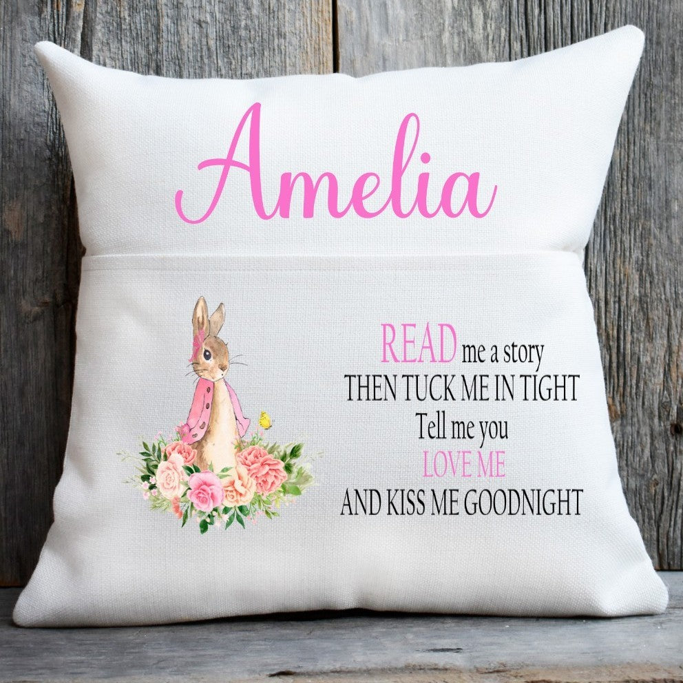 Pillow with a bunny illustration and text on a wooden background