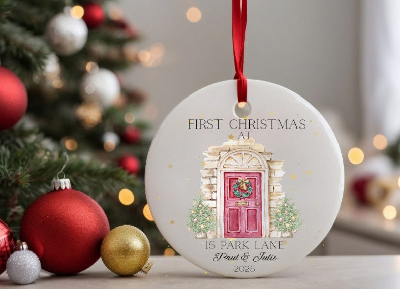 Christmas ornament with 'First Christmas at 15 Park Lane' text and door illustration, surrounded by festive decorations.