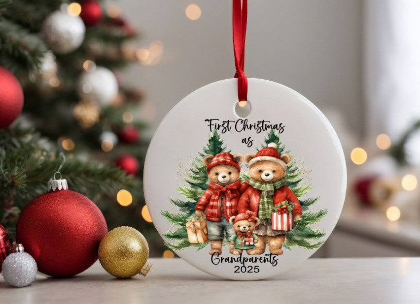 Christmas ornament with teddy bears and text 'First Christmas as Grandparents 2025' in front of a decorated tree.