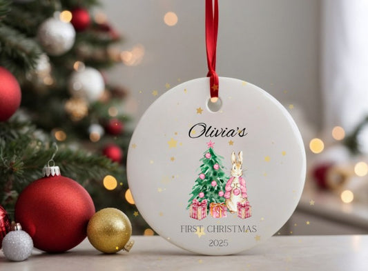 Personalised Christmas ornament with a tree and gift design, featuring the name 'Olivia's' and 'First Christmas 2025'.