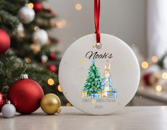 Personalised Christmas ornament with a rabbit and tree design, placed in front of a decorated Christmas tree.