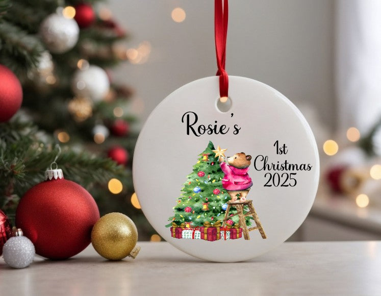 white ceramic Christmas bauble with a Christmas tree and pink London bear