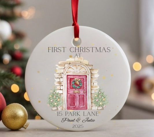 Decorative Christmas ornament with a pink door and wreath, hanging against a festive background.